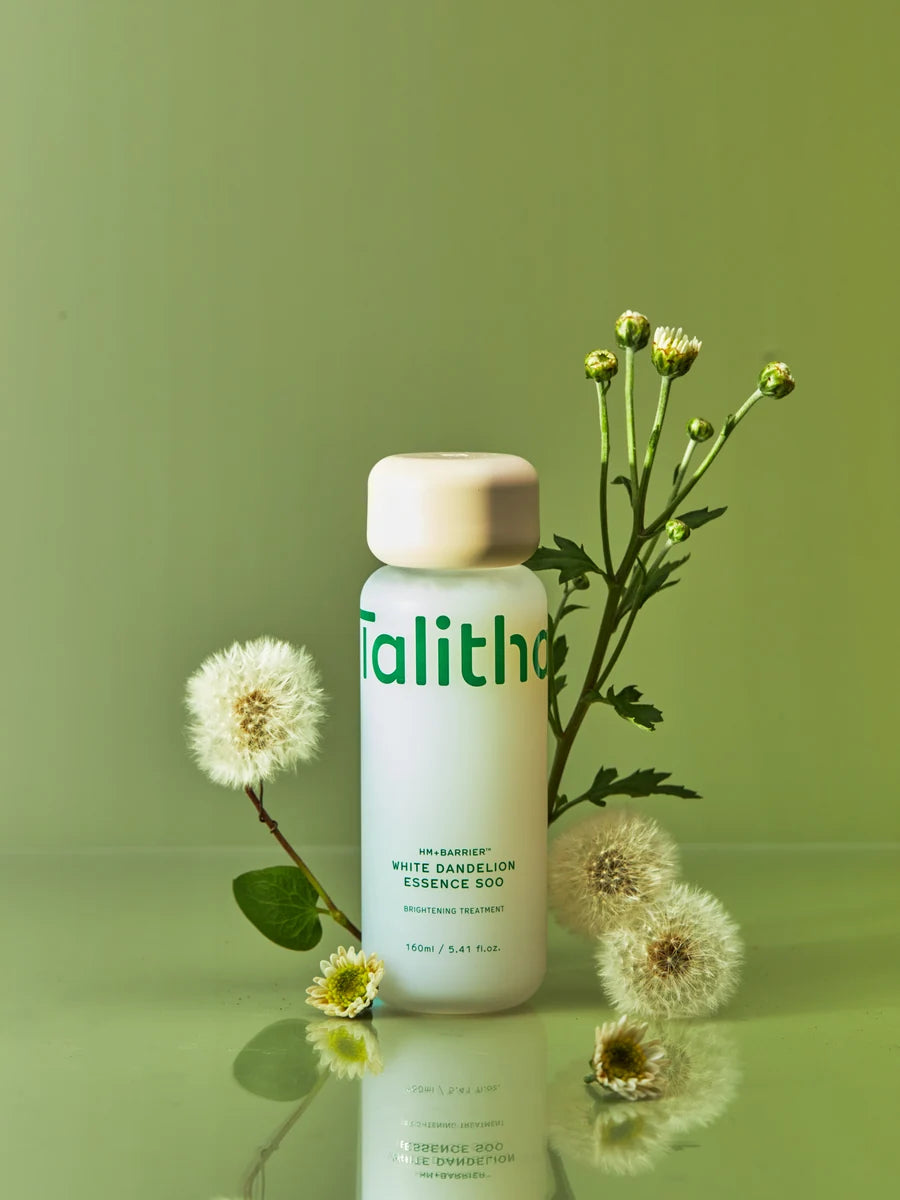Essence Soo surrounded by White Dandelion flowers and leaves.
