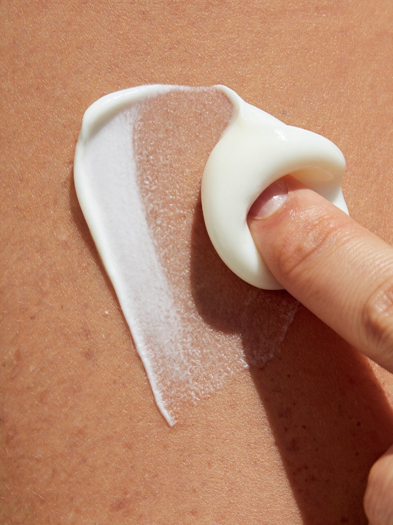 Face Cream spread on skin with a fingertip