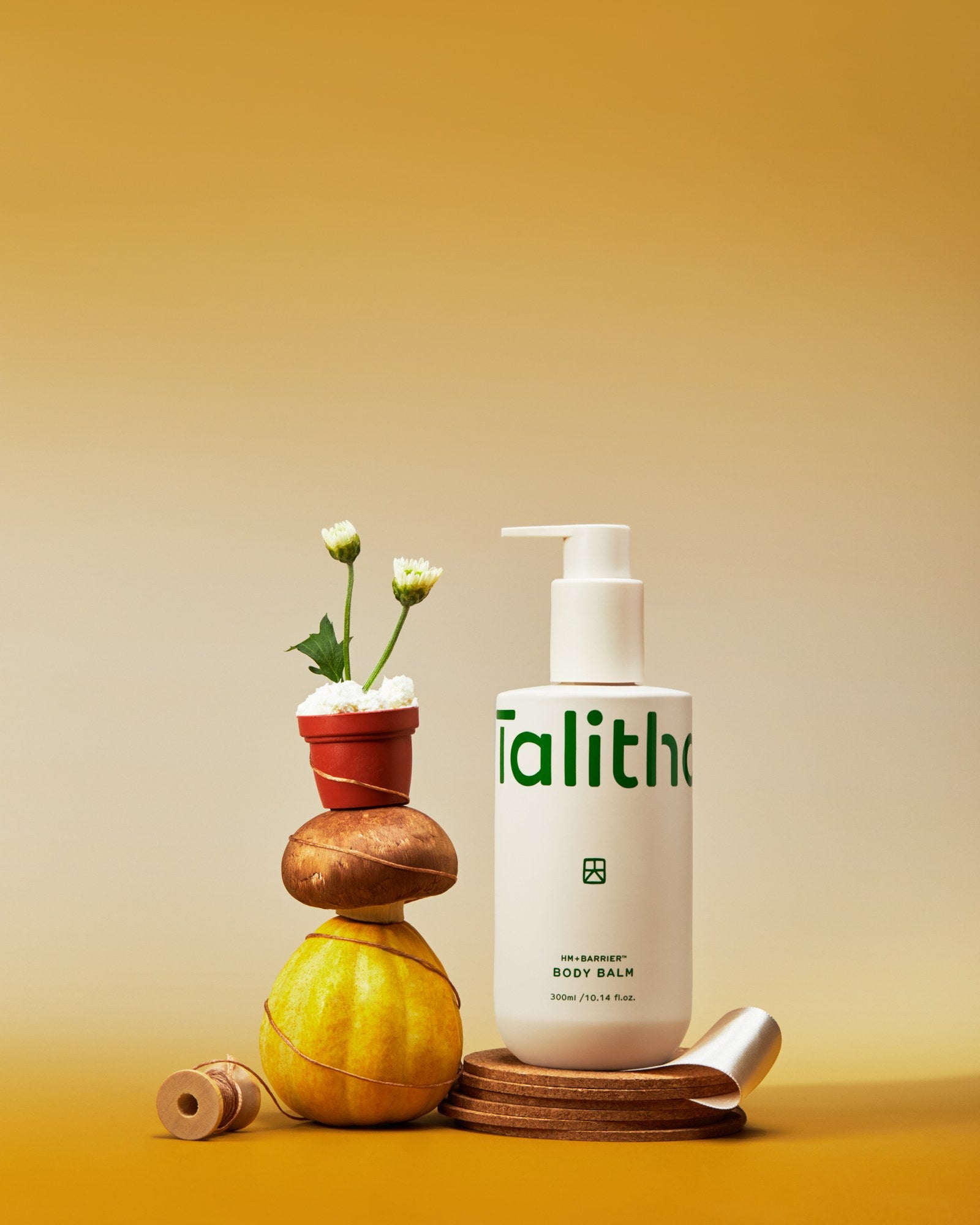 Body Balm styled with stacked stones and flowers
