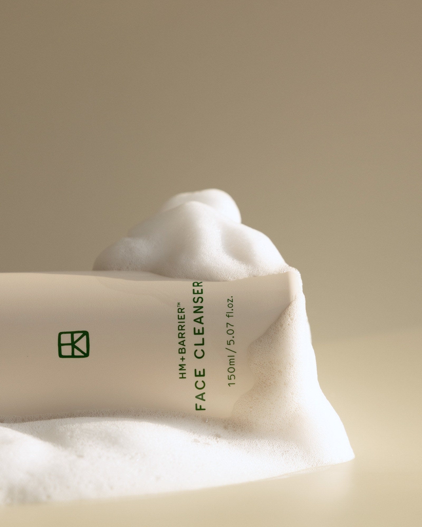 Close-up of Face Cleanser resting in soft white foam