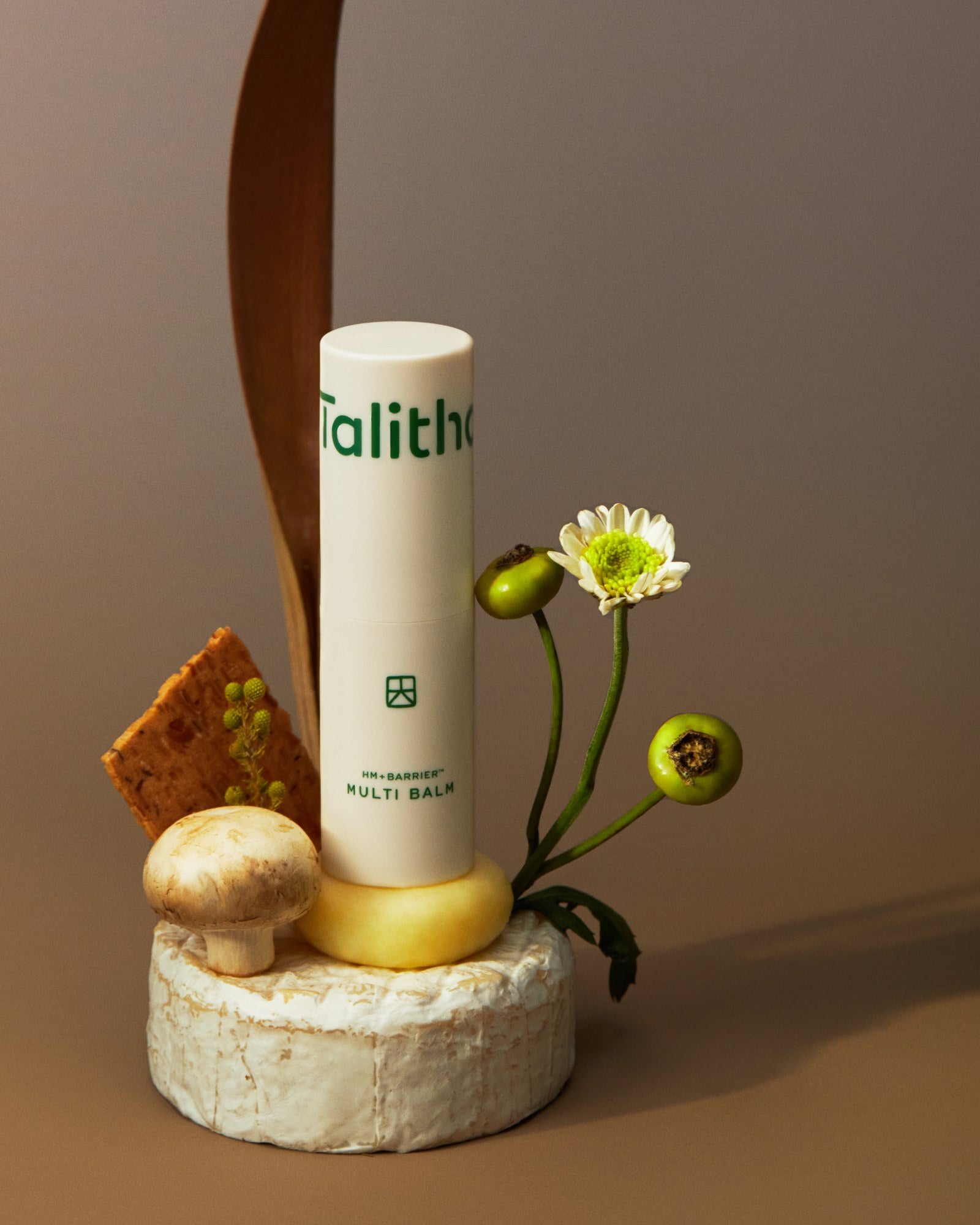 Multi Balm styled with flowers on a stone