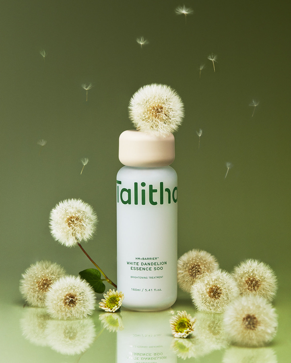 Essence Soo 160ml surrounded by white dandelion puffs
